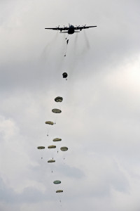 Paratroopers descend to earth from a Royal Air Force Hercules aircraft during a demonstration of their skills. Over 120 troops from A Company, 3 PARA, ( 3rd Battalion, The Parachute Regiment) demonstrated their skills to forty NATO Defence Attaches as part of the Airborne Task Force. The attaches watched as the Para's deployed out of two C130 Hercules aircraft flying at 800 feet above the Everleigh Dropping Zone (DZ) on Salisbury Plain. The Exercise, named EAGLES FLIGHT, included Helicopter assaults and Rapid Air Landings at South Cerney airfield. 3 PARA's main role along with 5th Battalion, Royal Regiment of Scotland, is to train as part of the British Army's rapid reaction force.